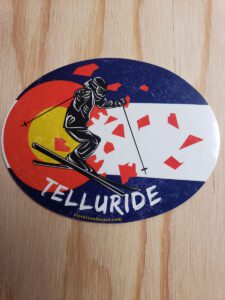 Telluride Skier busting out of a Grunge Colorado Flag
