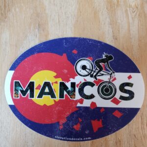 Mancos female Mountain bike rider on a Colorado flag