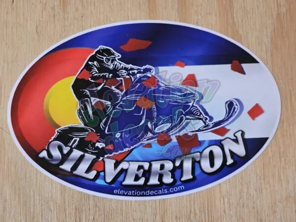 Silverdale snowmobile rider with Colorado flag